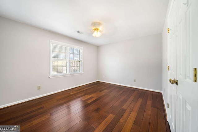 931 New Bedford Dr, Marietta, GA 30068 - empty room featuring visible vents, dark wood-type flooring, and baseboards