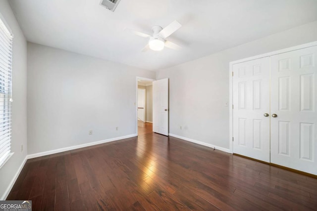 931 New Bedford Dr, Marietta, GA 30068 - unfurnished bedroom featuring visible vents, a ceiling fan, dark wood-style floors, a closet, and baseboards