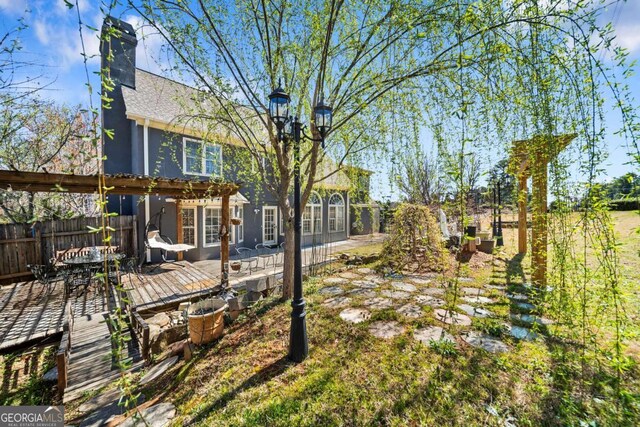 931 New Bedford Dr, Marietta, GA 30068 - view of yard with outdoor dining space, fence, and a wooden deck