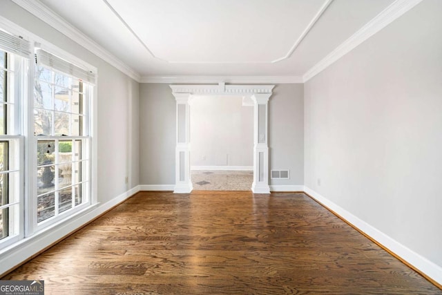 931 New Bedford Dr, Marietta, GA 30068 - unfurnished room with wood finished floors, visible vents, ornate columns, baseboards, and crown molding