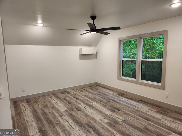 11637 Brown Bridge Rd, Covington, GA 30016 - unfurnished room with a wall mounted AC, vaulted ceiling, a ceiling fan, and wood finished floors