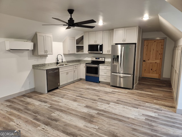 11637 Brown Bridge Rd, Covington, GA 30016 - kitchen featuring appliances with stainless steel finishes, an AC wall unit, lofted ceiling, open shelves, and light stone countertops