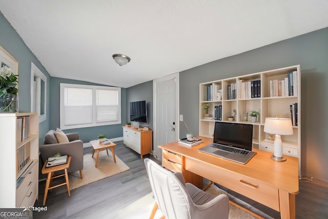 home office with wood finished floors and lofted ceiling