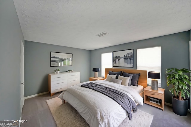 bedroom featuring baseboards and a textured ceiling