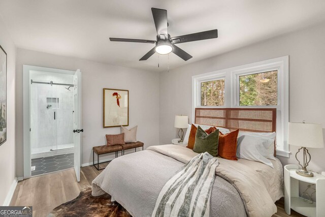 bedroom with connected bathroom, baseboards, wood finished floors, and a ceiling fan