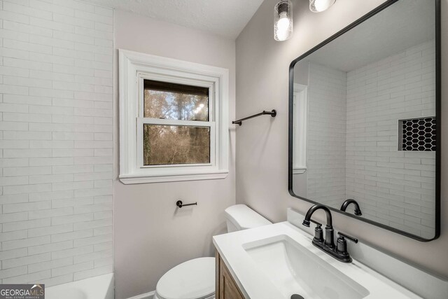 bathroom with toilet and vanity