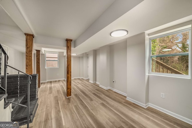 basement with stairway, baseboards, and wood finished floors