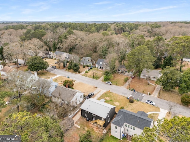 aerial view with a wooded view and a residential view