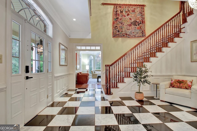 1575 Oak Mountain Rd, Shiloh, GA 31826 - entrance foyer featuring a decorative wall, ornamental molding, stairway, a wainscoted wall, and a high ceiling