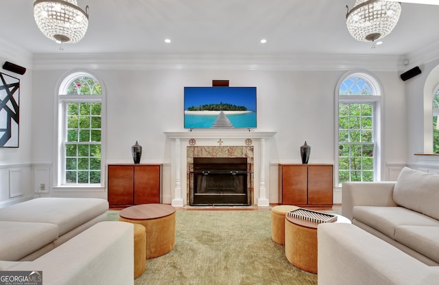 1575 Oak Mountain Rd, Shiloh, GA 31826 - living room featuring crown molding, a decorative wall, a premium fireplace, a wainscoted wall, and a chandelier