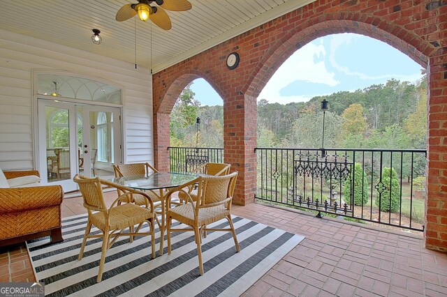 1575 Oak Mountain Rd, Shiloh, GA 31826 - view of patio / terrace with french doors, ceiling fan, a view of trees, outdoor dining space, and a balcony