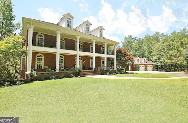 1575 Oak Mountain Rd, Shiloh, GA 31826 - neoclassical home with a porch, a front yard, driveway, and a garage