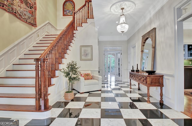 1575 Oak Mountain Rd, Shiloh, GA 31826 - entrance foyer with crown molding, a decorative wall, a chandelier, a wainscoted wall, and stairs
