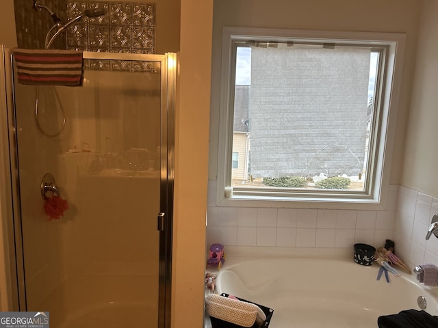 2478 Oakleaf Rdg, Lithonia, GA 30058 - bathroom featuring plenty of natural light, a stall shower, and a bath