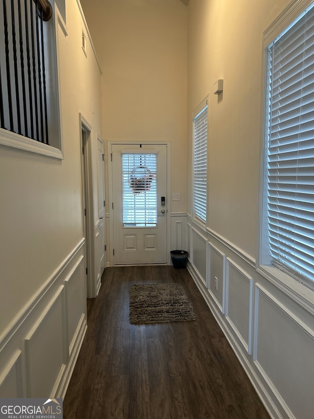 2478 Oakleaf Rdg, Lithonia, GA 30058 - doorway featuring wainscoting, wood finished floors, a decorative wall, and a high ceiling