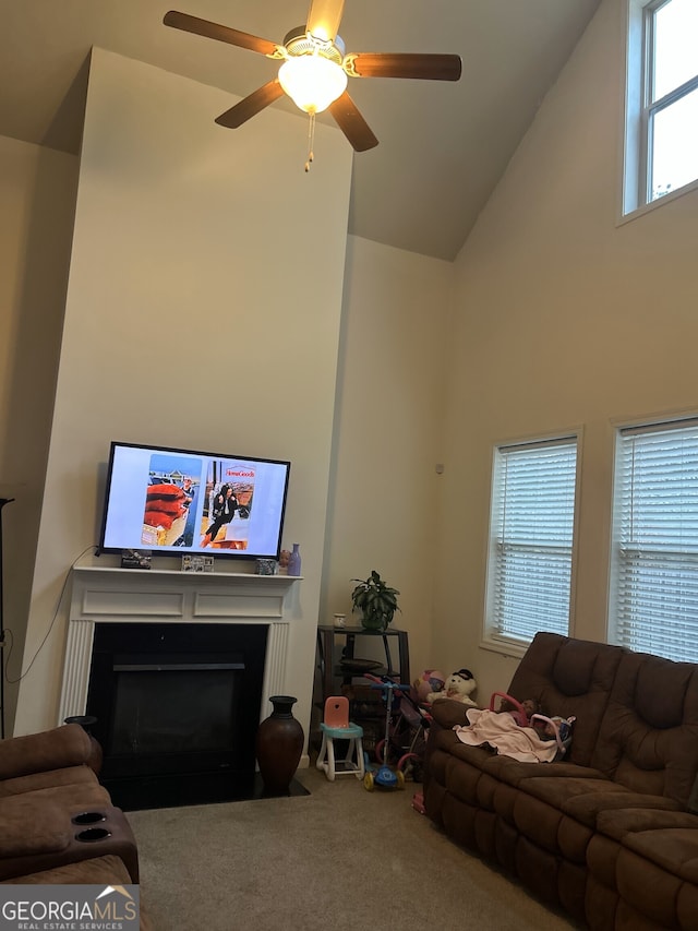 2478 Oakleaf Rdg, Lithonia, GA 30058 - carpeted living room with high vaulted ceiling, a fireplace with flush hearth, and a ceiling fan