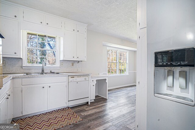 kitchen with wall oven, light countertops, a textured ceiling, and white cabinetry