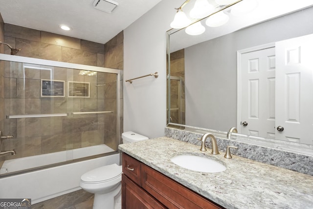 full bathroom with toilet, vanity, visible vents, and combined bath / shower with glass door