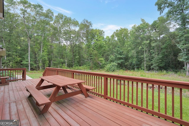 wooden deck featuring a yard and outdoor dining space