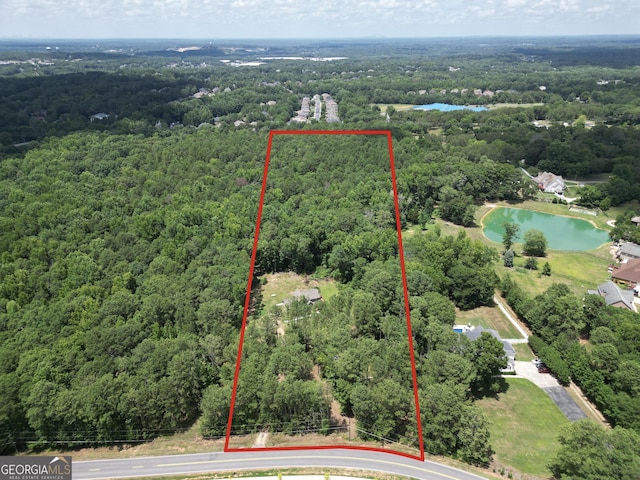 aerial view featuring a view of trees and a water view
