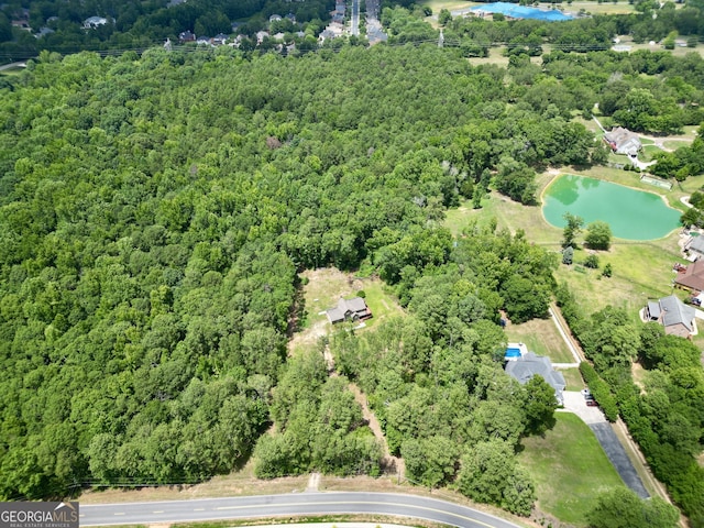 bird's eye view with a view of trees and a water view
