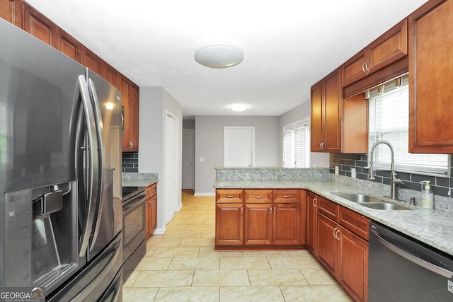 kitchen featuring decorative backsplash, appliances with stainless steel finishes, a sink, and plenty of natural light