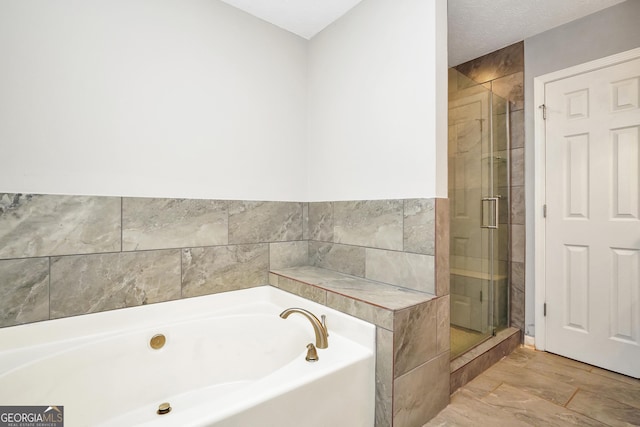 bathroom with a garden tub and a stall shower