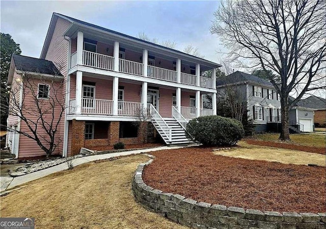 3348 Summit Turf Ln, Snellville, GA 30078 - view of front of property with stairway, a balcony, a front lawn, and covered porch