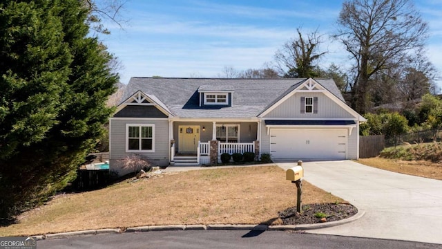 craftsman house featuring a garage, covered porch, concrete driveway, and fence