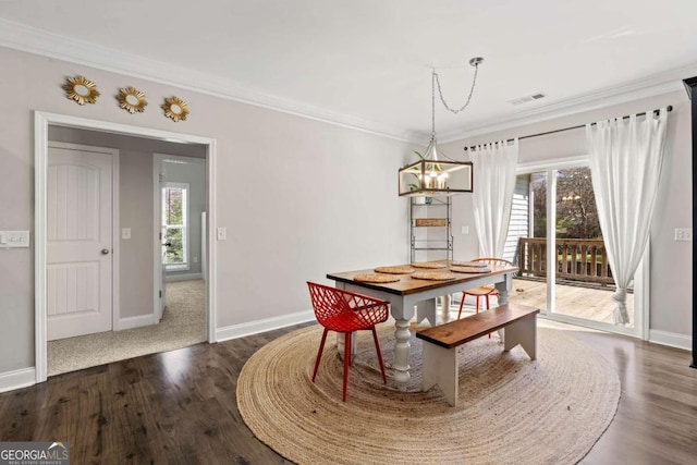 dining room with baseboards, a notable chandelier, dark wood-style flooring, and crown molding