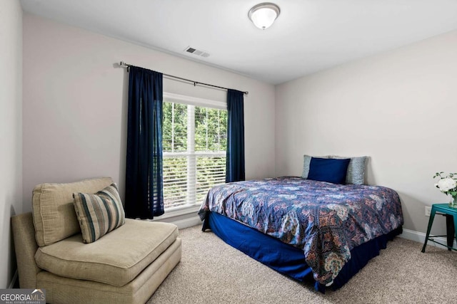 bedroom featuring visible vents, baseboards, and carpet