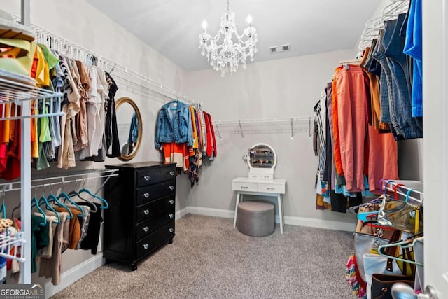 spacious closet featuring a chandelier, visible vents, and carpet