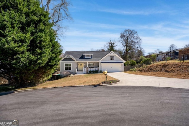 view of front of home with concrete driveway, a front yard, and fence