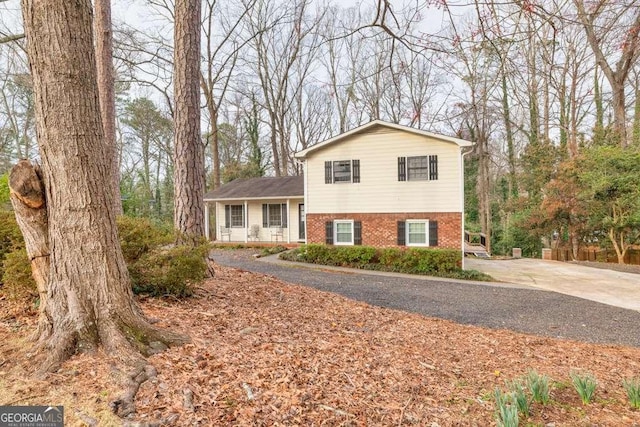 1417 Hickory Dr SW, Lilburn, GA 30047 - view of front of home with brick siding and driveway