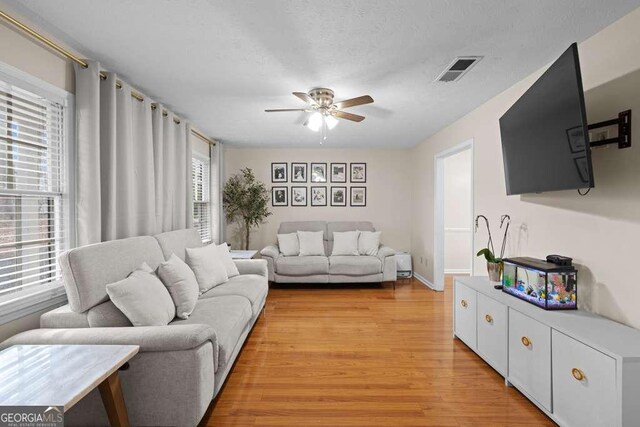 1417 Hickory Dr SW, Lilburn, GA 30047 - living area with a ceiling fan and light wood-style floors