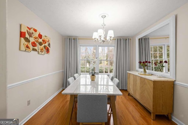 1417 Hickory Dr SW, Lilburn, GA 30047 - dining room featuring a chandelier and light wood-style flooring