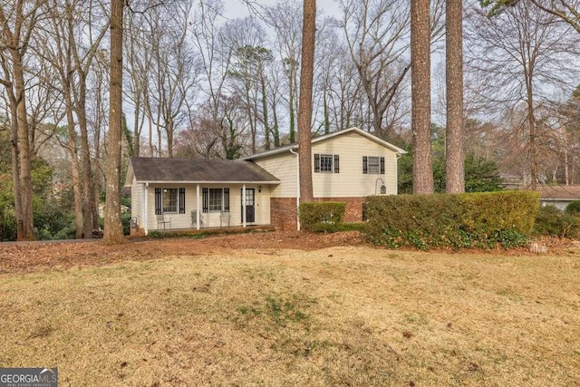 1417 Hickory Dr SW, Lilburn, GA 30047 - split level home featuring brick siding and a front lawn