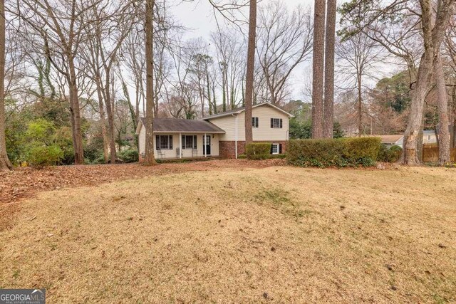 1417 Hickory Dr SW, Lilburn, GA 30047 - split level home featuring brick siding and a front lawn