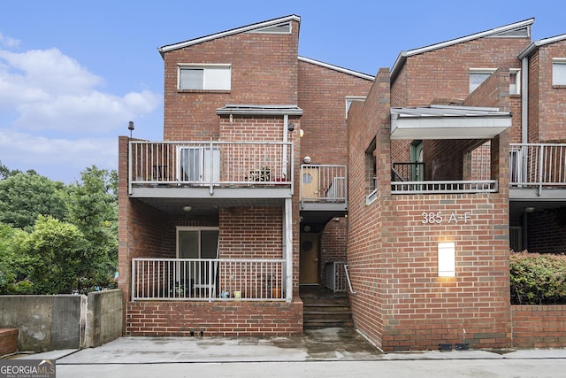 385 Ralph Mcgill Blvd NE Unit D, Atlanta, GA 30312 - rear view of house with a balcony and brick siding