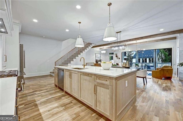 kitchen with a sink, light brown cabinetry, light wood finished floors, and stainless steel dishwasher