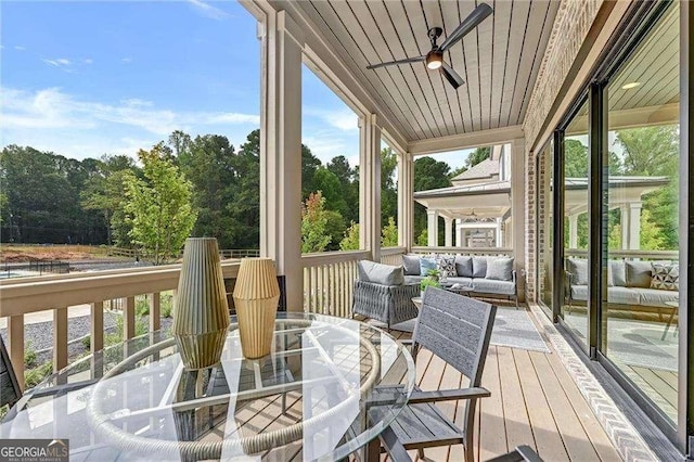 deck with outdoor lounge area, outdoor dining area, and ceiling fan