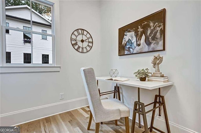 dining room with baseboards and wood finished floors