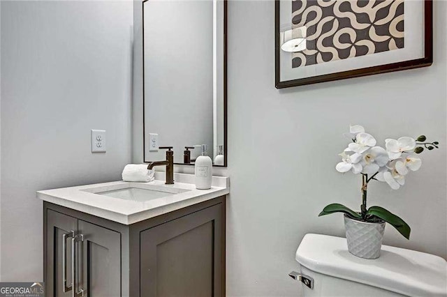 half bathroom featuring toilet and vanity