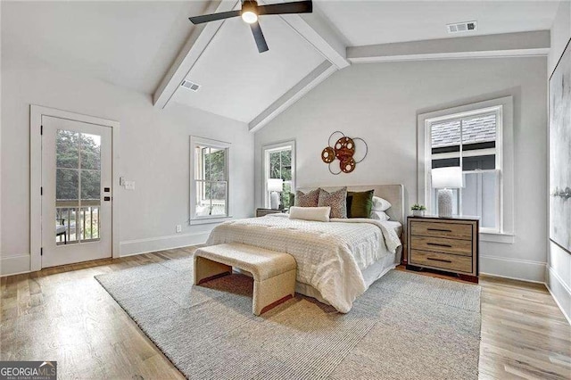 bedroom with light wood-type flooring, lofted ceiling with beams, and visible vents