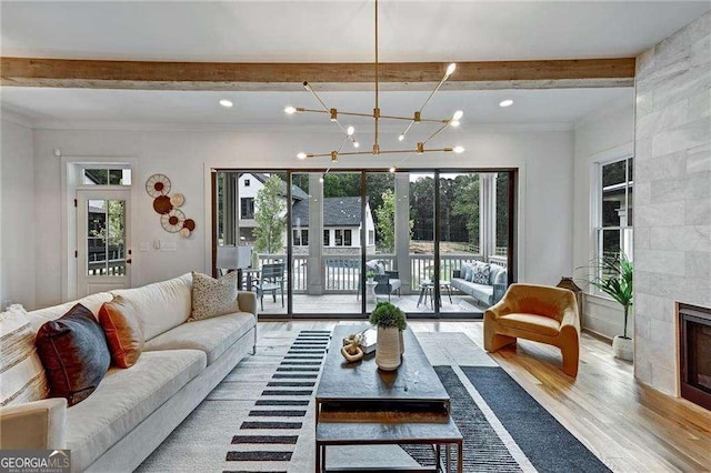 living area featuring a notable chandelier, beamed ceiling, light wood finished floors, and recessed lighting