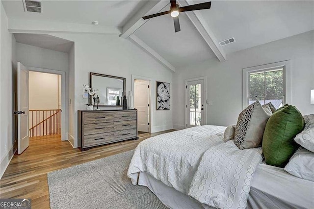 bedroom featuring light wood-style flooring, vaulted ceiling with beams, baseboards, and visible vents
