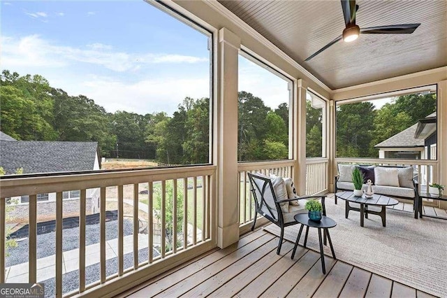 sunroom / solarium with an outdoor hangout area, a wealth of natural light, and a ceiling fan