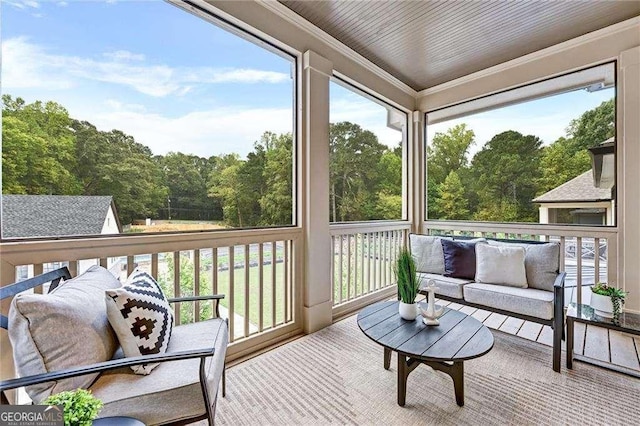 sunroom / solarium with an outdoor living space and plenty of natural light