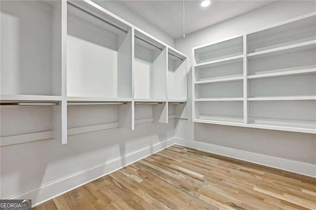 spacious closet with wood finished floors