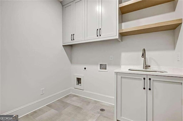 washroom featuring hookup for a washing machine, baseboards, a sink, cabinet space, and electric dryer hookup